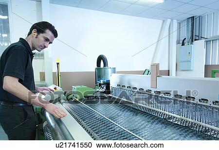 Worker operating carbon fibre loom in carbon fibre factory View Large Photo Image Stock Image - Worker operating carbon fibre loom in carbon fibre factory. Fotosearch