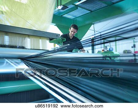 Worker operating carbon fibre loom in carbon fibre factory View Large Photo Image Stock Image - Worker operating carbon fibre loom in carbon fibre factory. Fotosearch