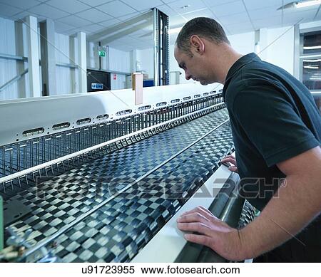 Worker operating carbon fibre loom in carbon fibre factory View Large Photo Image Stock Photography - Worker operating carbon fibre loom in carbon fibre factory. Fotosearch