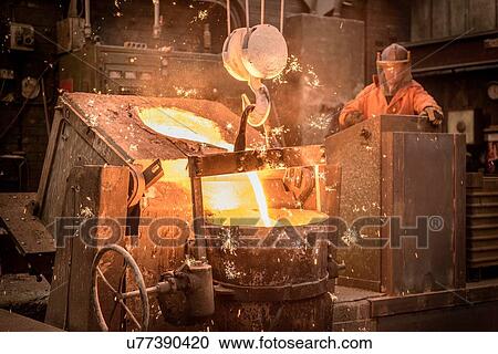 Worker pouring molten metal in foundry View Large Photo Image Stock Image - Worker pouring molten metal in foundry. Fotosearch