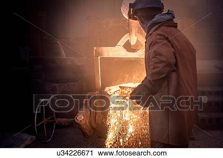 Worker raking molten steel in foundry View Large Photo Image Stock Image - Worker raking molten steel in foundry. Fotosearch