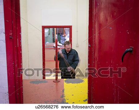 Worker sweeping up in factory View Large Photo Image Stock Photograph - Worker sweeping up in factory. Fotosearch