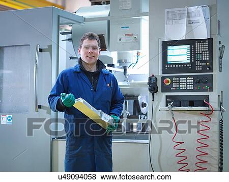 "Worker using CNC machine in plastics factory, portrait" View Large Photo Image Stock Photo - "Worker using CNC machine in plastics factory, portrait". Fotosearch