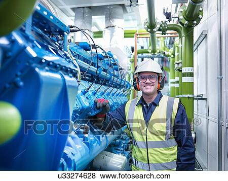 Worker with gas fired generator in gas fired power station View Large Photo Image Stock Photo - Worker with gas fired generator in gas fired power station. Fotosearch