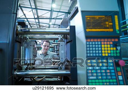 Worker with plastic injection moulding machine in plastics factory View Large Photo Image Stock Photography - Worker with plastic injection moulding machine in plastics factory. Fotosearch
