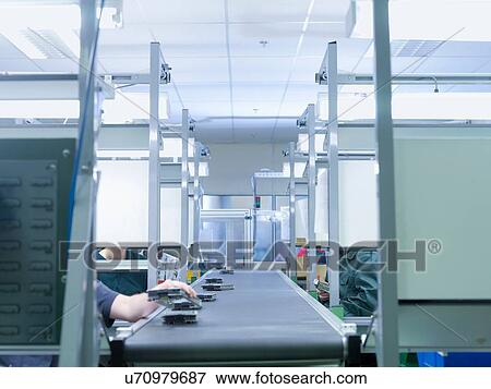 Workers assembling parts in factory View Large Photo Image Stock Photo - Workers assembling parts in factory. Fotosearch