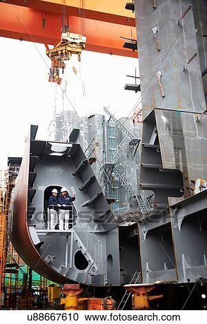 Stock Image - "Workers at shipyard, GoSeong-gun, South Korea". Fotosearch