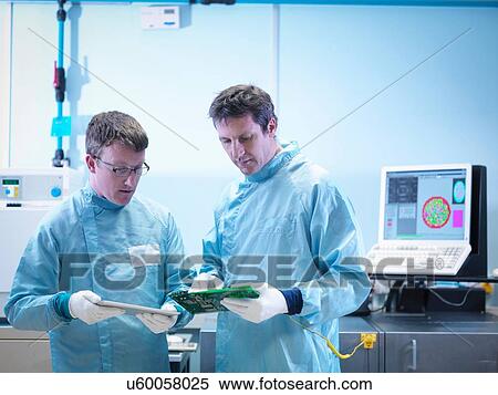 Stock Photography - Workers checking electronics in clean room laboratory. Fotosearch