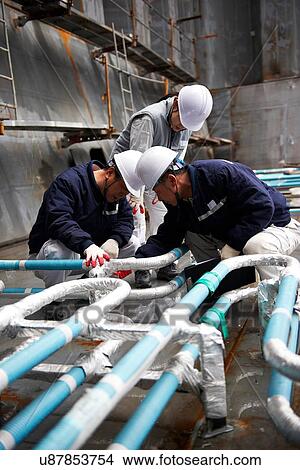 "Workers checking pipework on container ship at shipyard, GoSeong-gun, South Korea" View Large Photo Image Picture - "Workers checking pipework on container ship at shipyard, GoSeong-gun, South Korea". Fotosearch