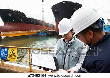"Workers having discussion at shipping port, GoSeong-gun, South Korea" View Large Photo Image Picture - "Workers having discussion at shipping port, GoSeong-gun, South Korea". Fotosearch