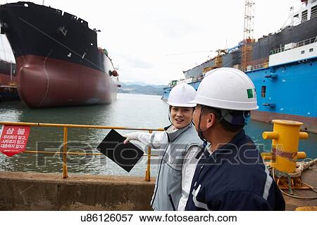 "Workers having discussion at shipping port, GoSeong-gun, South Korea" View Large Photo Image Stock Photo - "Workers having discussion at shipping port, GoSeong-gun, South Korea". Fotosearch