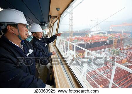 "Workers having discussion overlooking shipping port, GoSeong-gun, South Korea" View Large Photo Image Stock Photography - "Workers having discussion overlooking shipping port, GoSeong-gun, South Korea". Fotosearch