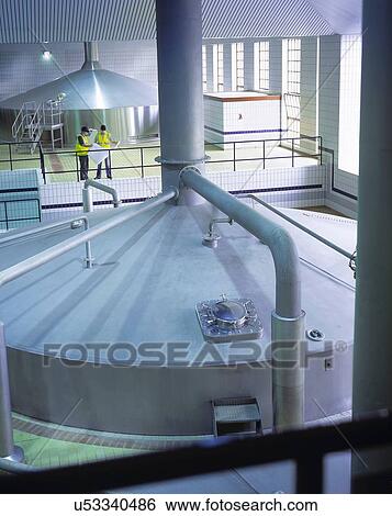 Workers in brewing hall of commercial brewery View Large Photo Image Stock Photograph - Workers in brewing hall of commercial brewery. Fotosearch
