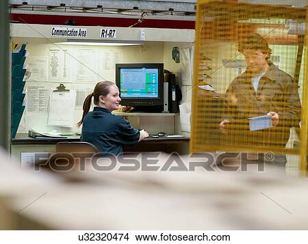 Workers in discussion in automotive parts factory View Large Photo Image Picture - Workers in discussion in automotive parts factory. Fotosearch
