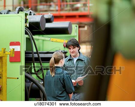 Workers in discussion in automotive parts factory View Large Photo Image Stock Image - Workers in discussion in automotive parts factory. Fotosearch