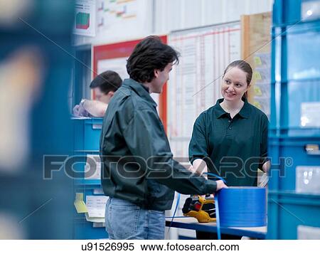 Workers in discussion in automotive parts factory View Large Photo Image Stock Photography - Workers in discussion in automotive parts factory. Fotosearch