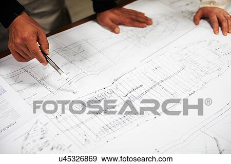 Stock Photo - "Workers looking at ship plans, focus on hands, GoSeong-gun, South Korea". Fotosearch