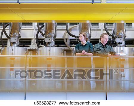 Workers on gantry in factory View Large Photo Image Stock Photo - Workers on gantry in factory. Fotosearch