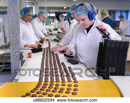 Workers on production line packing chocolates in chocolate factory View Large Photo Image Picture - Workers on production line packing chocolates in chocolate factory. Fotosearch