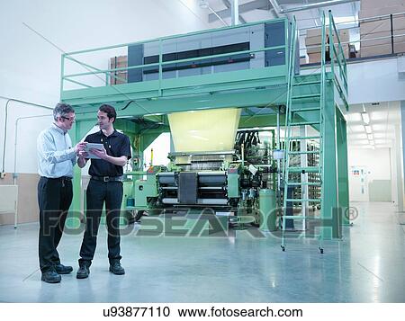 Workers using digital tablet with carbon fibre loom in carbon fibre factory View Large Photo Image Stock Image - Workers using digital tablet with carbon fibre loom in carbon fibre factory. Fotosearch