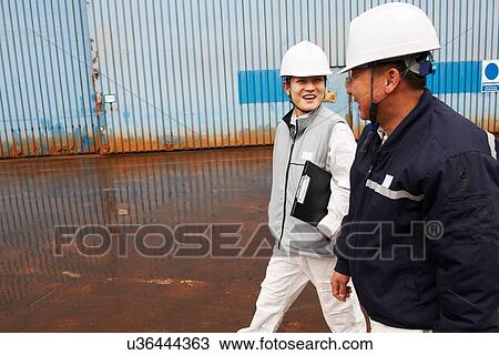 Stock Image - "Workers walking through shipyard, GoSeong-gun, South Korea". Fotosearch