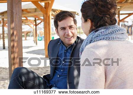 "Young couple chatting in shade at beach, Tel Aviv, Israel" View Large Photo Image Stock Photo - "Young couple chatting in shade at beach, Tel Aviv, Israel". Fotosearch