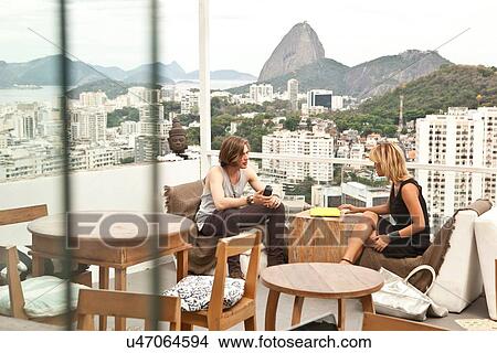 "Young couple chatting on rooftop terrace, Rio De Janeiro, Brazil" View Large Photo Image Picture - "Young couple chatting on rooftop terrace, Rio De Janeiro, Brazil". Fotosearch