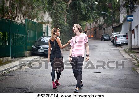 Young couple flirting on suburban street View Large Photo Image Picture - Young couple flirting on suburban street. Fotosearch