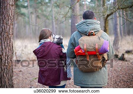 Young couple hiking together in forest View Large Photo Image Stock Photo - Young couple hiking together in forest. Fotosearch