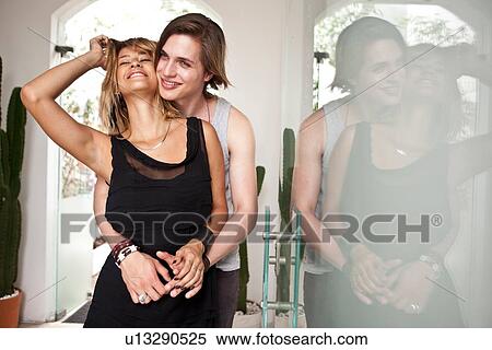 Young couple hugging in hotel lobby View Large Photo Image Stock Photography - Young couple hugging in hotel lobby. Fotosearch