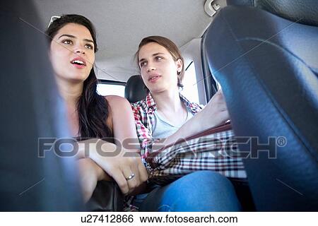 Young couple in car View Large Photo Image Stock Photograph - Young couple in car. Fotosearch