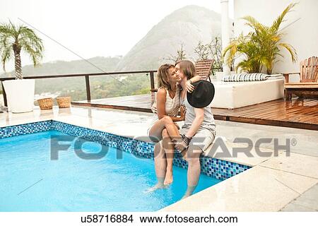 "Young couple kissing at rooftop swimming pool, Rio De Janeiro, Brazil" View Large Photo Image Picture - "Young couple kissing at rooftop swimming pool, Rio De Janeiro, Brazil". Fotosearch
