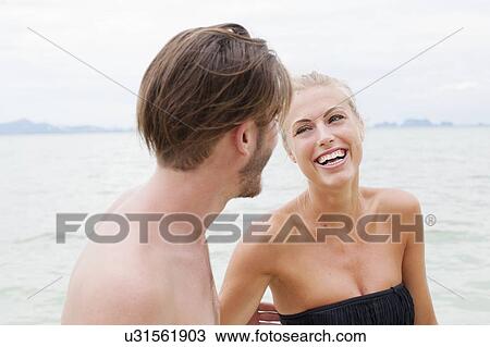 "Young couple laughing on beach, Kradan, Thailand" View Large Photo Image Stock Image - "Young couple laughing on beach, Kradan, Thailand". Fotosearch