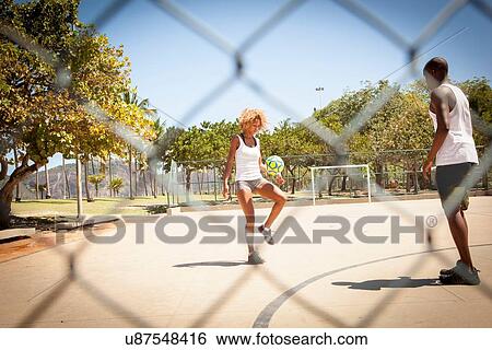 Young couple practicing together on basketball court View Large Photo Image Stock Photograph - Young couple practicing together on basketball court. Fotosearch