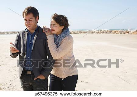 "Young couple reading smartphone texts on beach, Tel Aviv, Israel" View Large Photo Image Stock Photography - "Young couple reading smartphone texts on beach, Tel Aviv, Israel". Fotosearch