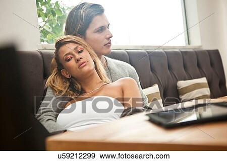 Young couple relaxing in hotel lobby View Large Photo Image Stock Photo - Young couple relaxing in hotel lobby. Fotosearch
