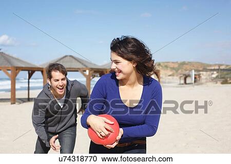 "Young couple running with ball on beach, Tel Aviv, Israel" View Large Photo Image Stock Image - "Young couple running with ball on beach, Tel Aviv, Israel". Fotosearch