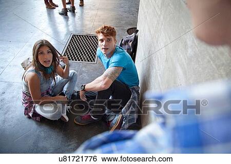Stock Photograph - Young couple sitting on floor. Fotosearch