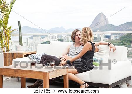 "Young couple sitting on rooftop terrace sofa, Rio De Janeiro, Brazil" View Large Photo Image Stock Photo - "Young couple sitting on rooftop terrace sofa, Rio De Janeiro, Brazil". Fotosearch