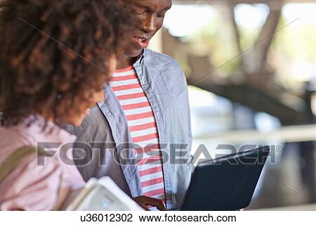 "Young couple using tablet, cropped image" View Large Photo Image Stock Image - "Young couple using tablet, cropped image". Fotosearch