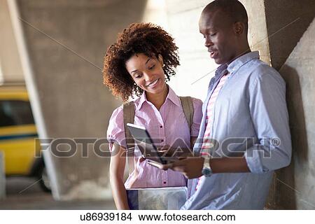 Picture - Young couple using tablet. Fotosearch
