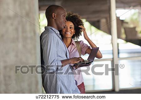 Young couple using tablet View Large Photo Image Stock Photography - Young couple using tablet. Fotosearch