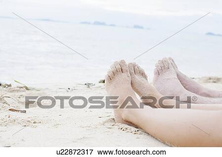 "Young couples legs on beach, Kradan, Thailand" View Large Photo Image Stock Photo - "Young couples legs on beach, Kradan, Thailand". Fotosearch
