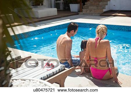 "Young family sitting on edge of outdoor swimming pool, rear view" View Large Photo Image Stock Image - "Young family sitting on edge of outdoor swimming pool, rear view". Fotosearch