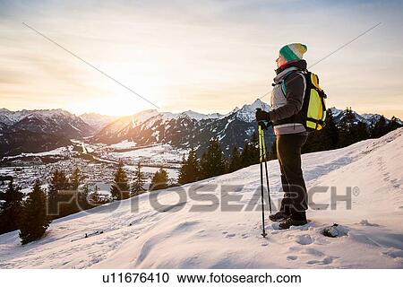 "Young female hiker looking out from mountainside, Reutte, Tyrol, Austria" View Large Photo Image Stock Image - "Young female hiker looking out from mountainside, Reutte, Tyrol, Austria". Fotosearch