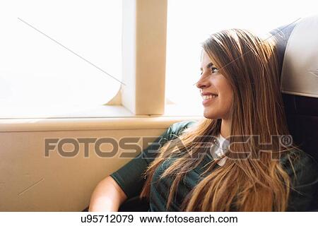 "Young female tourist gazing out of train carriage window, Macau, Hong Kong, China" View Large Photo Image Stock Photo - "Young female tourist gazing out of train carriage window, Macau, Hong Kong, China". Fotosearch