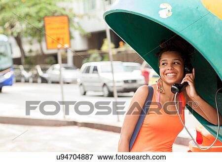 "Young female tourist using street phone booth, Copacabana town, Rio De Janeiro, Brazil" View Large Photo Image Stock Photo - "Young female tourist using street phone booth, Copacabana town, Rio De Janeiro, Brazil". Fotosearch