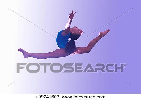 Stock Image - Young gymnast in mid-air leap. Fotosearch