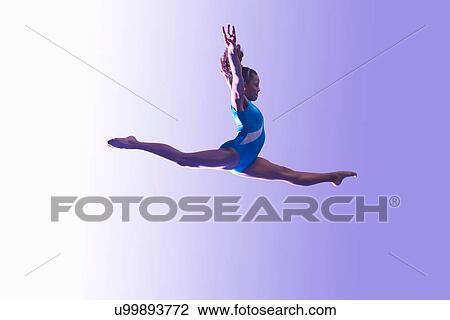 Stock Image - Young gymnast in mid-air leap. Fotosearch