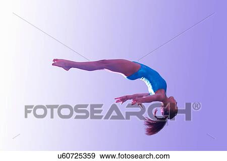 Young gymnast in mid-air leap View Large Photo Image Stock Photo - Young gymnast in mid-air leap. Fotosearch